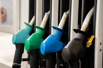 Different gasoline pumps on a gas station. Petrol fuel prices concept