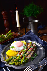 delicious green asparagus wrapped in bacon and egg