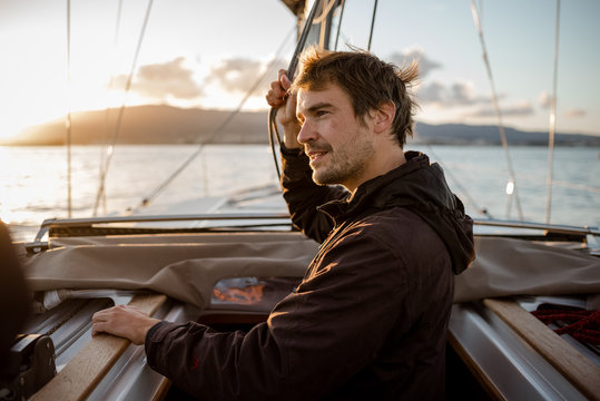 man on a sailing trip at sunset