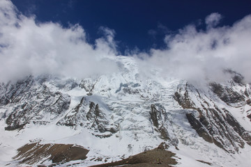 Obraz premium Snowy mountains against the blue sky with white clouds. Mountains of Nepal