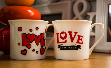 Two white coffee, tea cups, mugs with love writings