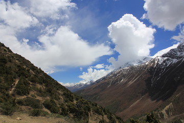 Snowy mountains against the blue sky with white clouds. Mountains of Nepal