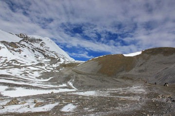 Snowy mountains against the blue sky with white clouds. Mountains of Nepal