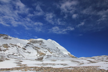 Snowy mountains against the blue sky with white clouds. Mountains of Nepal