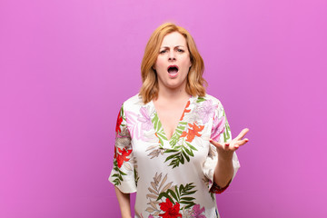 middle age woman looking angry, annoyed and frustrated screaming wtf or what‚Äôs wrong with you