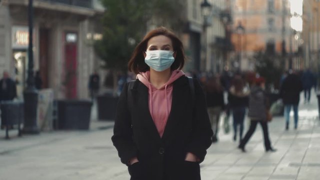Pandemic in china, portrait of a young tourist woman wearing protective mask on street crowd people. the concept health and safety, N1H1 coronavirus, virus protection