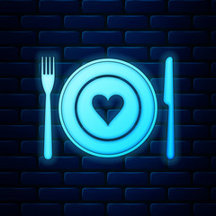 Glowing neon Heart on plate, fork and knife icon isolated on brick wall background. Happy Valentine's day. Vector Illustration