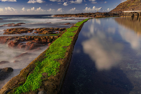 El Pris pool wall with green moss, close to Atlantic ocean with volcanic rocks, long exposure photography, Tacoronte, Tenerife, Canary islands, Spain