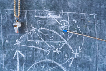 Soccer or football tactics scribble with the trainers whistle and pointer stick on blackboard....