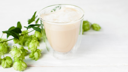 Obraz na płótnie Canvas Morning drink. Energy aroma. Hot latte beverage in glass. Natural hop decor.