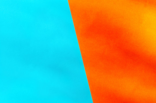 Double background texture with copy space. Two papers of blue and orange color with a place for the text. view from above. Contrast colors