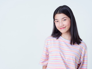 Fototapeta premium Smiling young woman over white background