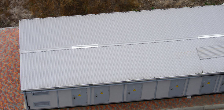 A building with a metal roof for a switchgear in an electrical power system. View from above.