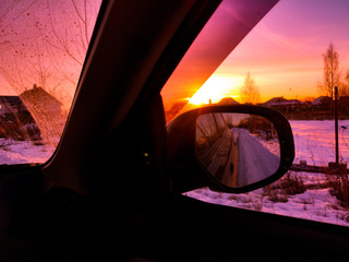 Car mirror at dawn in the winter.