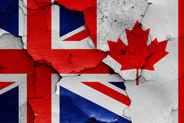 flags of UK and Canada painted on cracked wall