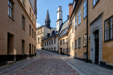 Fototapeta na wymiar Deserted street of the old city, paved with stone. Stockholm, Sweden.