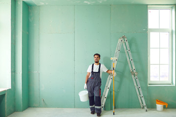 Bearded painter construction worker on a construction site.