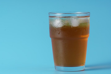 Ice tea over blue background