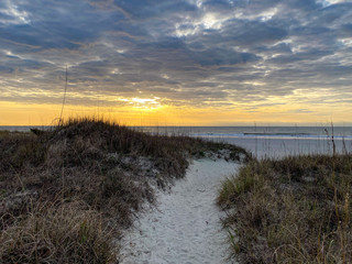 Path On Sand Dunes Heading Towards Ocean During Sunset