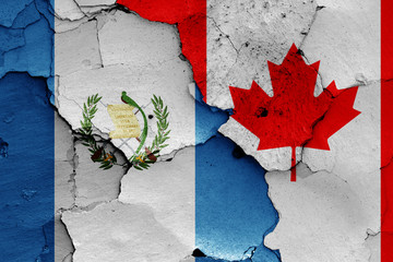 flags of Guatemala and Canada painted on cracked wall