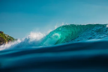 Gordijnen Barrel wave in sea. Blue wave with sun light © artifirsov