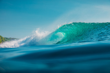 Barrel wave in sea. Blue wave with sun light