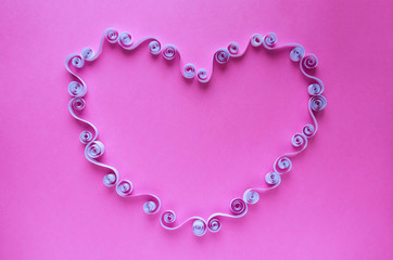 Openwork heart on a pink background