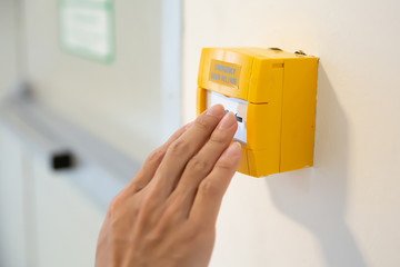 Firefighters hands are pressing the emergency switch. In the event of a fire.