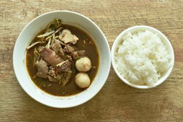 braised pork and ball with bean sprout in brown soup on bowl  eat couple plain rice