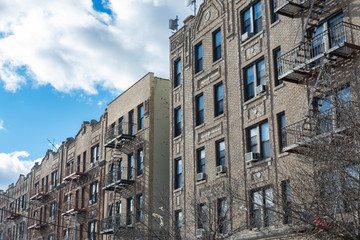 A Row of Old Brick Residential Buildings with Fire Escapes in Astoria Queens New York	