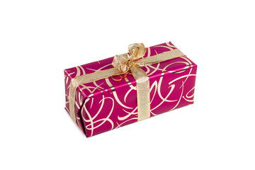 packaged rectangular gift in dark pink packaging with gold bow and gold pattern on the white background
