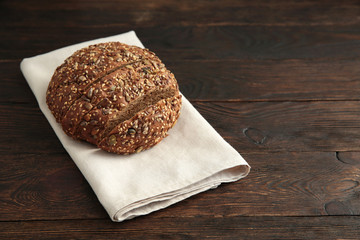 Rustic bread on an old vintage planked wood table. Dark moody background with free text space.