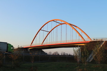 Fototapeta na wymiar Rzeszow, Poland - 9 9 2018: Suspended road bridge across the autobahn. Metal construction technological structure. Modern architecture