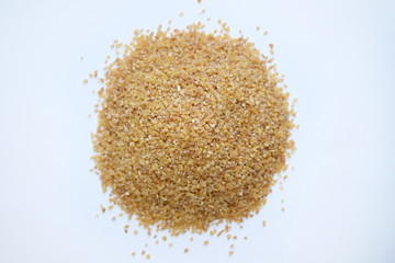 barley groats on a white background top view. Raw crushed barley grains for making porridge.