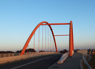 Fototapeta na wymiar Rzeszow, Poland - 9 9 2018: Suspended road bridge across the autobahn. Metal construction technological structure. Modern architecture