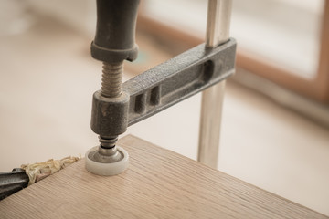 Wooden boards clamped together in the furniture assembly workshop