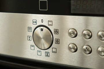 Kitchen oven stainless steel panel with buttons and knobs
