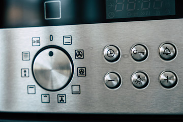 Kitchen oven stainless steel panel with buttons and knobs