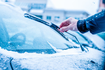 Windshield wiper in hand. Concept of cleaning and maintaining the wiper during winter