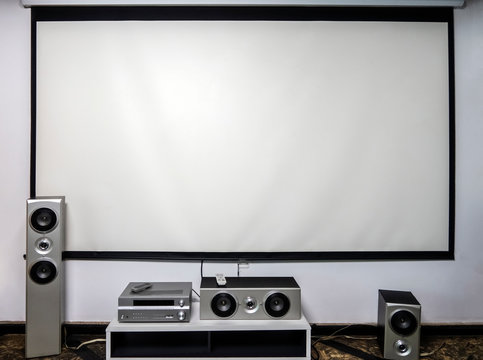 Home cinema. Large white screen home theater system with stereo