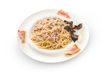 spaghetti with carbonara in a creamy sauce sprinkled with parmesan. White plate with tasty and aromatic pasta on a white plate, isolated