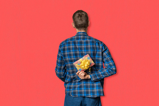 View From Behind Man Holding A Paper Gift Box To Make A Surprise On The Holiday