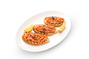 Bruschetta with salmon and avocado dried rye baguette, cream cheese, salmon, Tobiko caviar, avocado, basil . Isolated image on white background.