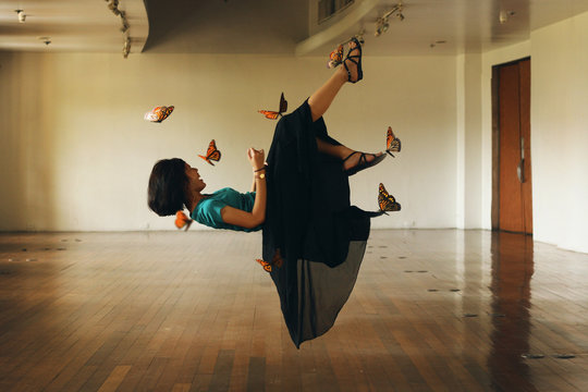 Optical Illusion Of Butterflies Holding Girl In Mid-Air At Room