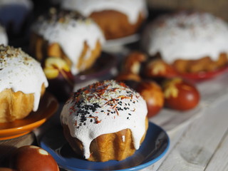 Easter. Traditional Easter pastries, painted onion peel eggs on a natural tablecloth. Night dark shots. Sprinkled with natural ingredients. Wooden ancient background. We celebrate the holiday.