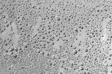 Wet glass water drops background texture pattern.