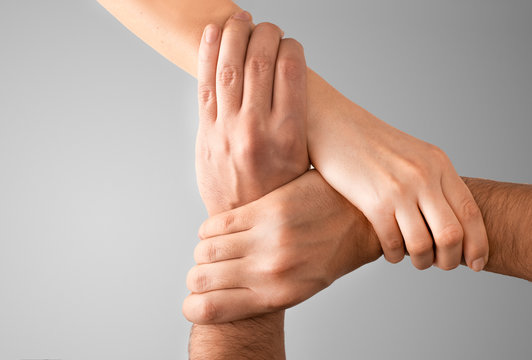 Top view of holding hands. Concept of unity, teamwork and support.