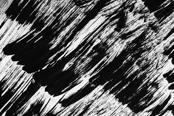 Patterns of black paint from a brush on a white background