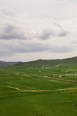 Fototapeta na wymiar Aerial view of the Mongolian countryside, not far from Ulaanbaatar, the capital of Mongolia, circa June 2019 