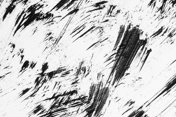 Patterns of black paint from a brush on a white background